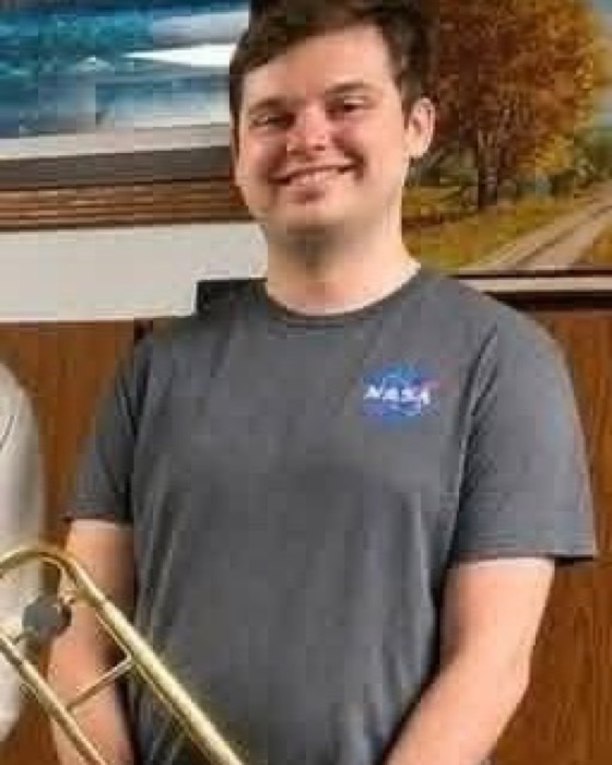 Cooper Tyson holding a trombone